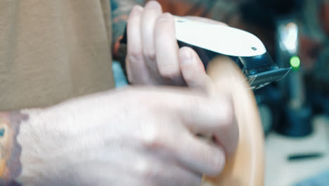 Close-up-of-hands-cleaning-clipper-after-using.-Barber-cleaning-electric-razor
