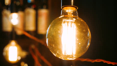 Bright-incandescent-bulbs-hang-and-shine-in-row.-Electric-lights-brightly-shine