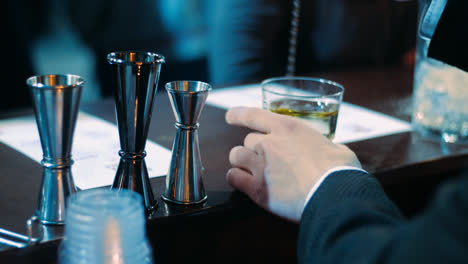 Barman-shaking-alcoholic-cocktail-in-glass-with-long-spoon.-Barman-equipment