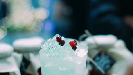 Refreshing-red-currant-drink-with-ice-in-glass.-Barman-making-berry-cocktail