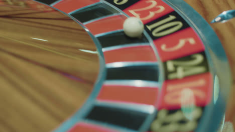 Casino-roulette-wheel-with-white-ball-on-black-sector-ten.-Gambling-concept