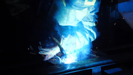 Welding-with-yellow-sparks-flying-away-in-darkness.-Dangerous-industrial-work