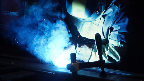 Professional-welder-working-with-argon-arc-welding-at-plant.-Technician-welding