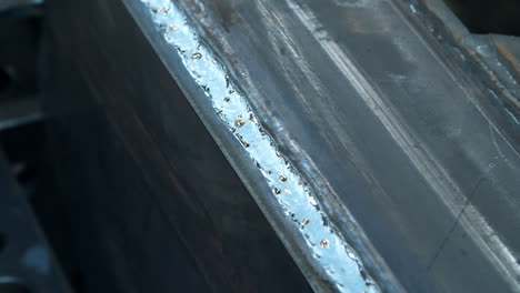 Close-up-of-metallic-surface-after-weld-influence.-Iron-with-traces-of-welding