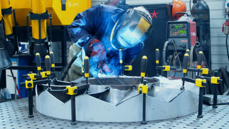 Worker-in-protective-mask-making-weld-of-industrial-unit.-Welding-process