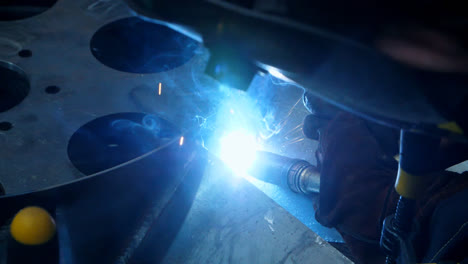 Close-up-of-welding-process-with-bright-sparks.-Nozzle-of-welding-machine
