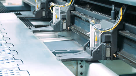 Special-robotic-technology-with-clips-moving-steel-sheet-along-conveyor-line