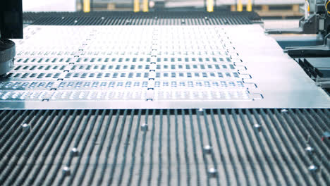 Metal-perforating-industrial-equipment-working-on-conveyor-line