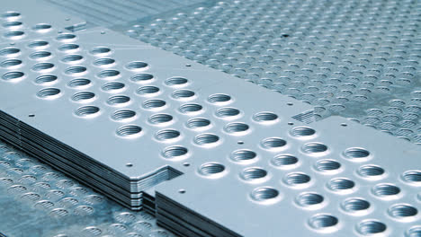 Metal-plates-with-perforations.-Steel-blanks-with-holes-at-warehouse-of-factory