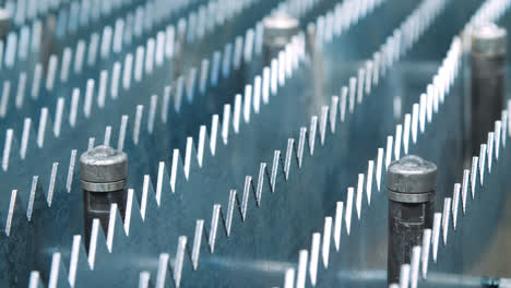 Rows-of-metal-plates-with-sharp-edges-in-machine-tool.-Manufacturing-process