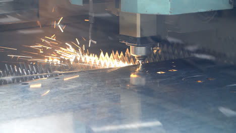 CNC-fiber-laser-cutting-machine-with-bright-sparks.-Metalworking-process