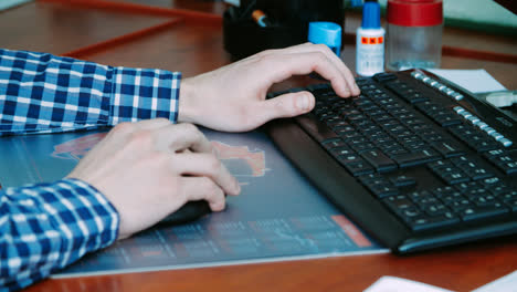 Freelancer-working-with-keyboard-and-computer-mouse.-Typing-text-on-keyboard