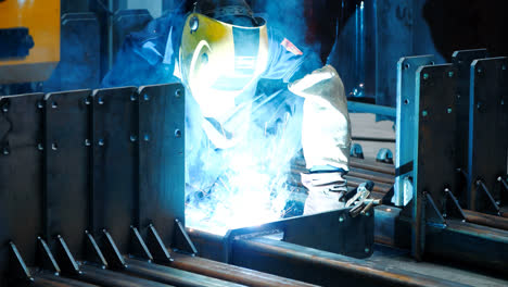 Welder-working-with-welding-machine-in-protective-mask.-Hazardous-work