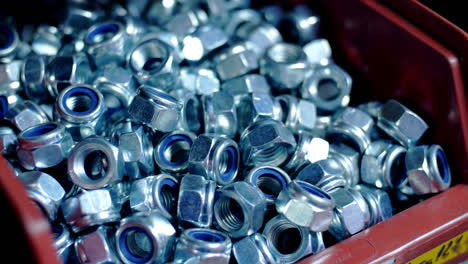 Final-product-of-metalworking-workshop.-Heap-of-chromed-nuts-with-rubber-seals