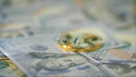 Cryptocurrency-finance-bitcoin-business.-Gold-bit-coin-lie-on-dollar-bills