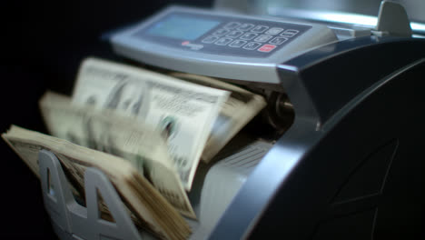 Electronic-banknote-counter-counting-dollar-bills.-Money-counting-machine