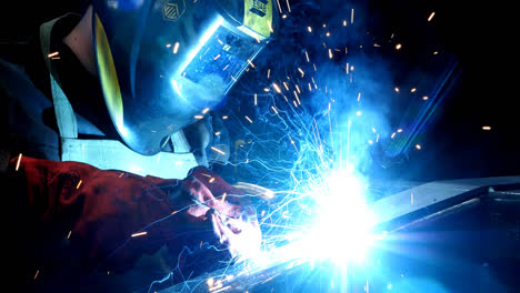 Welder-working-with-electrode-at-semi-automatic-arc-welding