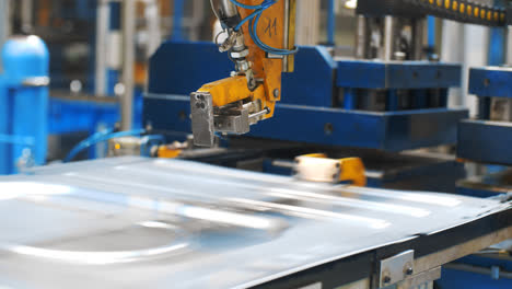 Metal-sheet-moving-on-manufacturing-line-at-factory.-Production-washing-machine