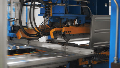 Robotic-equipment-assembling-washing-machine-from-metal-detail-at-plant