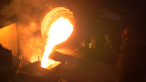 Industrial-worker-casting-metal-at-metallurgical-factory.-Molding-molten-metal