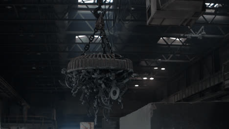 Industrial-magnet-lifting-scrap-metal.-Magnetic-crane-transporting-metal-waste