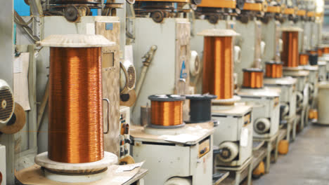 Copper-wire-winding-on-coils-at-factory.-Bronze-cable-rolling-on-reels-at-plant
