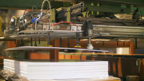 Automatic-manipulator-holding-plastic-sheet.-Production-plastic-detail-at-plant