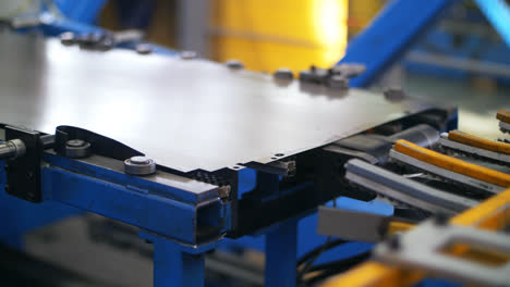 Steel-sheet-moving-on-conveyor-line.-Processing-metal-at-industrial-factory