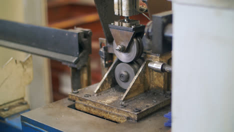 Processing-metal-detail-on-automatical-lathe-in-metalworking-workshop