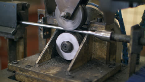 Lathe-machine-processing-metal-shaft-at-metalworking-factory