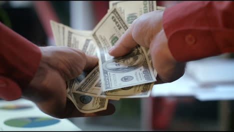 POV-view-of-male-hands-counting-money-cash-in-bank-office
