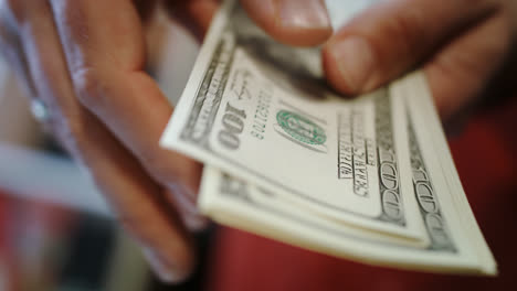 Human-hands-counting-dollar-bills.-Close-up-of-hands-count-money-cash