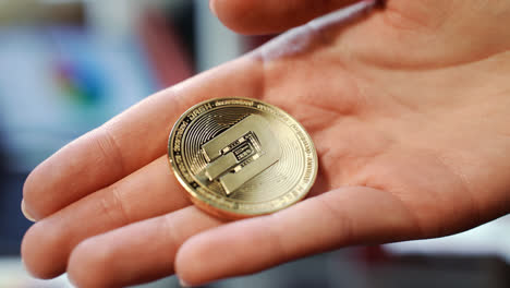 Woman-hand-holding-gold-dash-coin.-Cryptocurrency-exchange-business