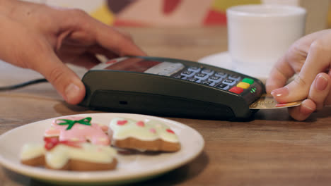 Pos-terminal-payment-for-order-in-cafe.-Woman-paying-with-chip-credit-card