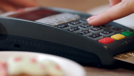 Credit-card-payment-for-order-in-cafe.-Woman-hand-enter-pin-code