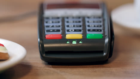 Human-hand-swipe-credit-card-in-pos-terminal.-Detail-of-card-terminal-payment