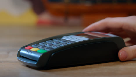 Shopping-with-credit-card.-Hand-with-credit-card-swipe-through-terminal
