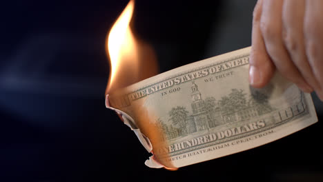 Male-hand-burning-dollar-banknote.-Man-burning-money-cash.-Financial-crisis