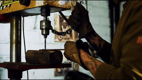 Mechanic-repair-and-construction.-Tattooed-craftsman-drilling-steel-plate