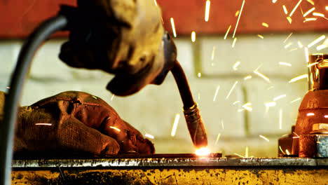 Welder-hands-working-with-welding-machine.-Electric-metal-welding-sparks