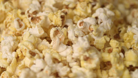Mixing-hot-popcorn-in-heap.-Close-up-of-fresh-popcorn-flakes.-Popping-up-popcorn