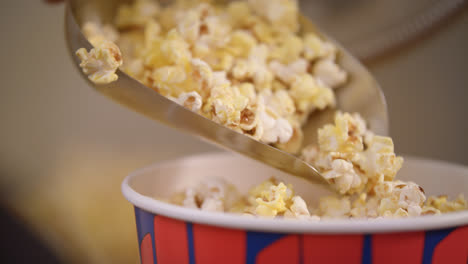 Popcorn-flakes-pouring-by-ladle-to-paper-container-in-slow-motion
