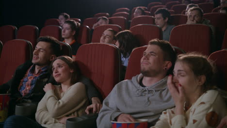 Young-people-watching-movie-in-cinema.-Romantic-date-at-cinema