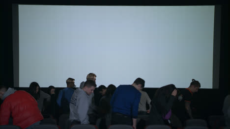 Spectators-applaud-film-that-ended.-Audience-leaving-cinema-applauding