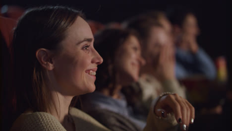 Woman-face-watching-funny-movie-at-cinema.-Cinema-people-watching-comedy-movie