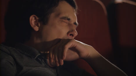 Man-yawning-at-cinema-chair.-Handsome-guy-sleeping-at-cinema.-Yawning-man-asleep