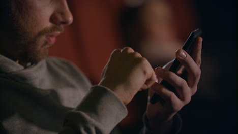 Male-hands-using-mobile-phone-in-cinema.-Man-hands-scrolling-phone-at-theatre