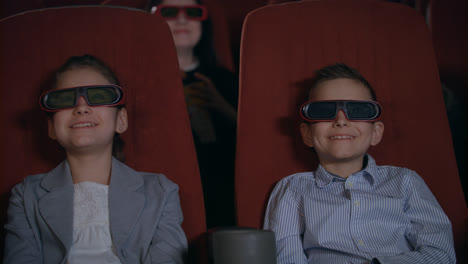 Excited-kids-watching-cartoon-in-3D-movie-theater.-Childhood-concept