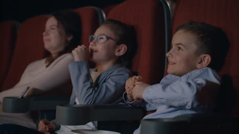 Children-watching-movie-enthusiastically-in-cinema.-Child-entertainment-concept