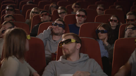 Man-talking-on-phone-in-cinema-hall.-Uncultured-man-disturb-people-in-cinema